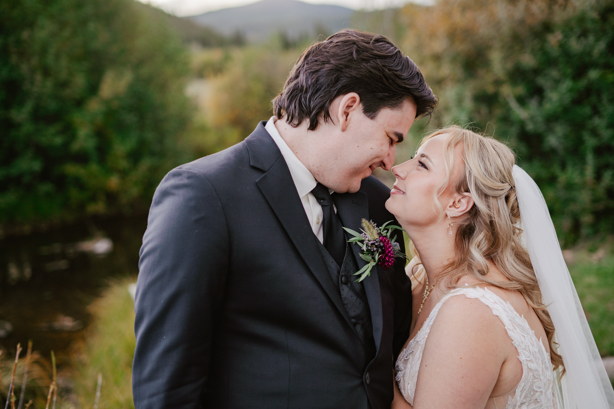 Mike and Julia smile at each other closely under the sunset at Beaver Meadows Resort Ranch