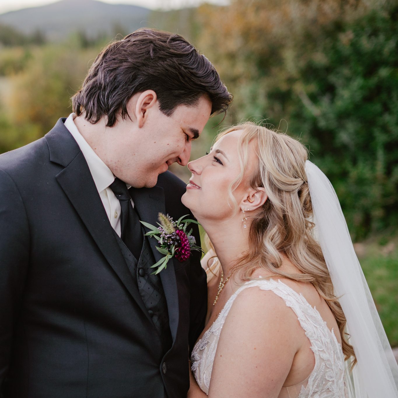 Mike and Julia smile at each other closely under the sunset at Beaver Meadows Resort Ranch